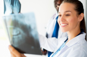A radiologist smiling at an X-ray.