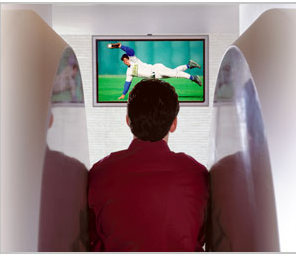 back view of a man sitting in the Fonar MRI machine