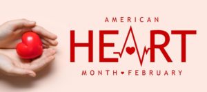 Hands holding a toy heart next to American Heart Month February.